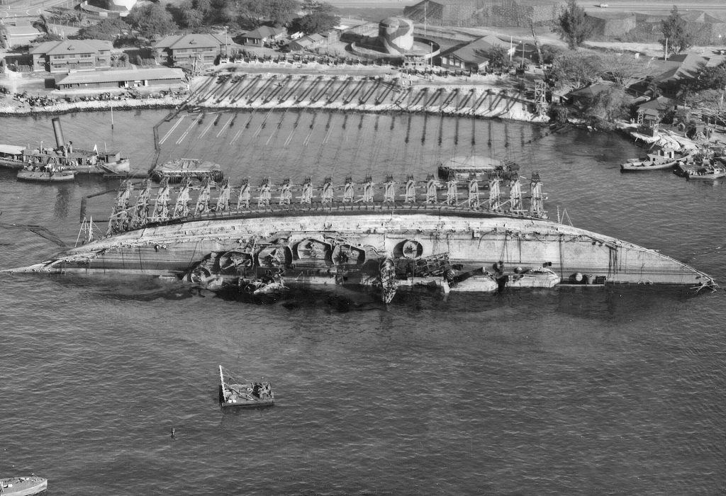 USS Oklahoma in 90 degrees position during the 'parbuckling' process.